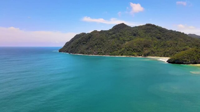 a Scenic Beach with a Hillside Backdrop