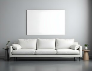 A white sofa with gray cushions in a minimalist living room setting, with a large blank white canvas hanging above the wall.