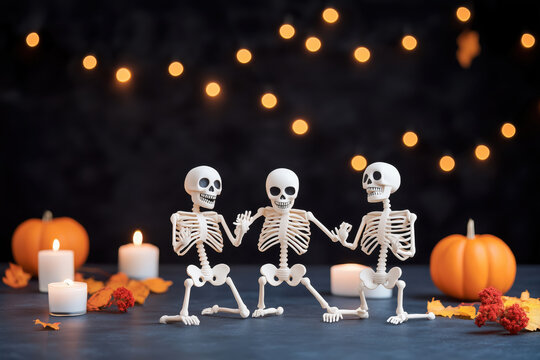 Spooky Skeleton Soiree: Three playful skeletons dance beneath twinkling lights, embracing the Halloween spirit amidst pumpkins and flickering candles. 