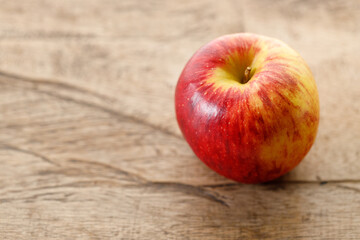 Ripe organic red apple on wooden table background.