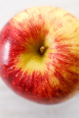 Ripe organic red apple on white table background.