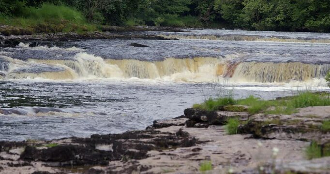 looking up the river ure at the start of the lower falls at Aysgarth falls, Yorkshire dales