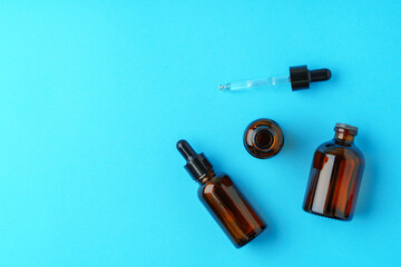 Collection of Amber Glass Bottles and Jars Displayed on Bright Blue Background