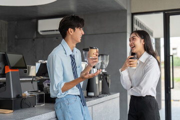 Colleagues enjoying a coffee break with laughter in cafe