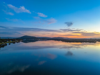 Sunrise along the waterfront with reflections on the bay water