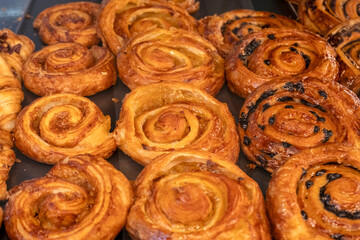 Confectionery, assortment of various pastries, cinnamon buns, croissants.
