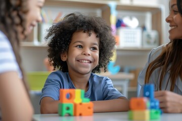 Obraz premium Portrait of a child with autism working with a therapist during a session, both smiling and interacting positively. The therapy room is welcoming and filled with educational tools.