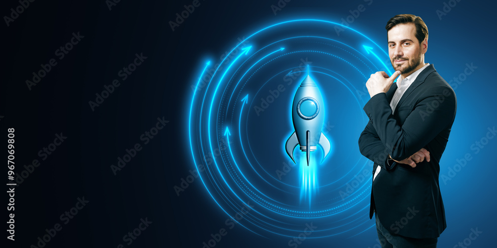 Poster attractive smiling young european businessman with glowing rocket on blue background with mock up pl