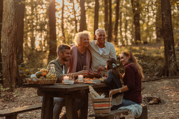 Family eating grapes at picnic in the forest