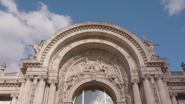 Statues above the entrance of The Petit Palais in Paris on a summer day