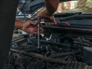 Close up Man hands fixing Car machinery vehicle mechanical service. Mechanic man hands repairing car auto repair shop. open vehicle hood checking up auto mobile. Vehicle Car maintenance engineer.