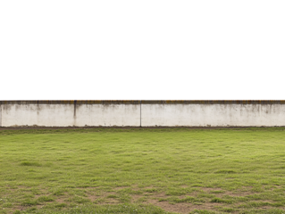 a grass field with a wall