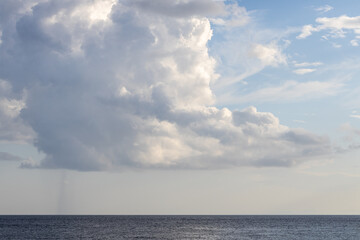 Landscape capture of dramatic clouds and open blue sky capture from seaside view