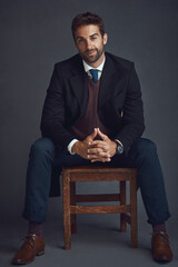 Portrait, businessman and chair in studio for fashion, confidence and smile for career growth....