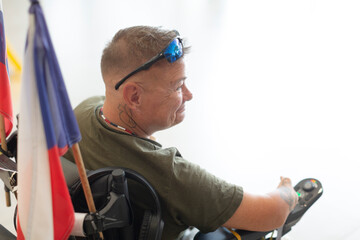 A resilient person in a wheelchair, showcasing strength and inspiration, with flags in the background.