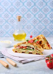 Breakfast, zucchini waffles with cucumber, shrimp, tomato and sauce filling on a gray concrete background. Savory waffle recipes.