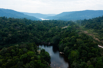 Aerial View of Lush Green Valley with River and Mountain Ranges
