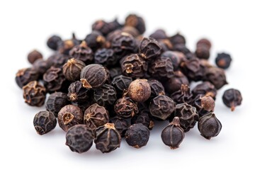 A compact pile of black pepper seeds on a white surface