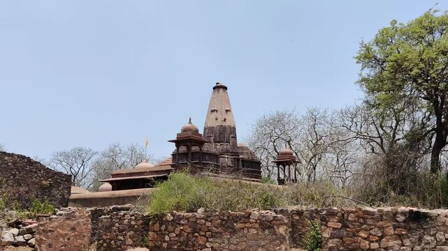 Footage of an ancient Jain Temple (Digambar Jain Temple of Ranthambore Fort) situated at Ranthambore Fort shot during daylight against blue sky
