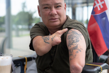 An incredibly striking image of a tattooed man, showcasing his resilience, courage, and unique individuality