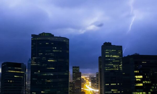 Dynamic night cityscape with dramatic lightning strikes among towering skyscrapers