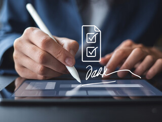 Business professional digitally signing a document on a tablet with a stylus, emphasizing electronic signature and online agreement.