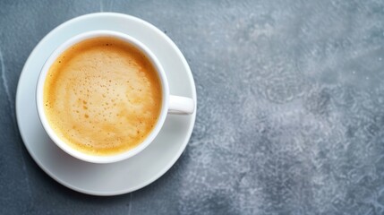 Freshly Brewed Cappuccino in a White Cup on a Saucer Against a Gray Textured Surface â€“ Perfect Morning Coffee Moment