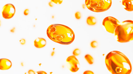 Golden oil capsules suspended in the air against a white background