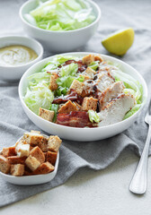 A bowl  of  Caesar salad