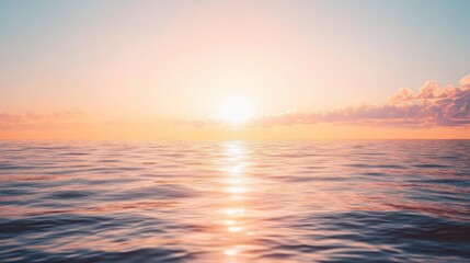 Fototapeta premium The sun is setting over the ocean, casting a warm glow on the water