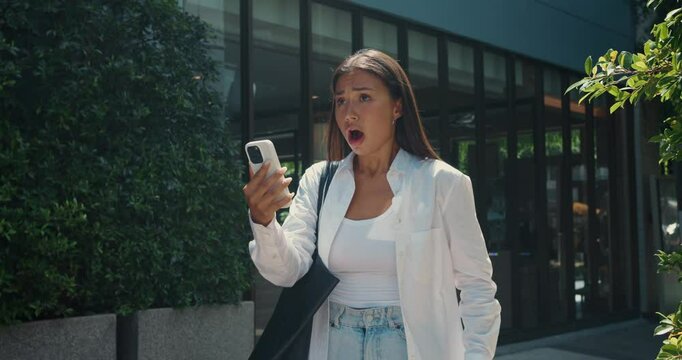 Young adult woman face fills with disbelief and shock she encounters troubling news online raw emotion and frustration. Female expression changes rapidly as she reads shocking news update.