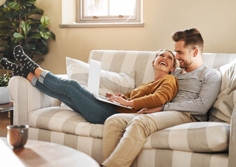 Happy couple, love or laptop in home for choice, news and loan option online on couch in living room. Relax, support or people chill in lounge on social network app on digital website or technology