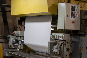 An industrial machine at a factory where wallpaper is produced.
