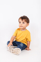 Portrait of a two-year-old boy looking up attentive in a studio shot
