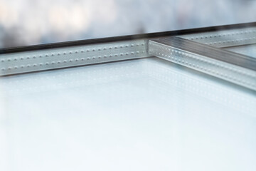 Wienersprossen is insulating double glazing, with metal spacers installed in the space between the two glass sheets. Plastic or wooden rods are later glued to the outside and inside