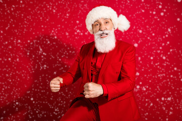 Photo of harsh crazy santa claus dance corporate party entertaining quests wear x-mas hat suit on red color background