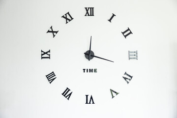 A clock with Roman numerals on it that says "Time" in the center