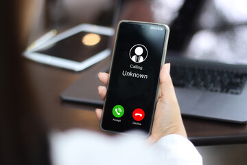 Unknown number displayed showing on smart mobile phone. Human use smartphone with incoming call...