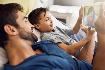 Obraz premium Selfie, tablet and love with father and son for live streaming, photography filter and technology. Social media, happiness and app with man and child in family home for internet, digital and website