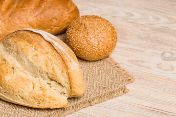 Homemade natural breads. Different kinds of fresh bread as background, perspective view with copy space