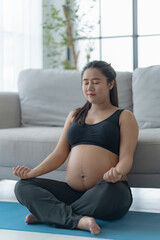 Asian female pregnancy doing meditation for mental health.