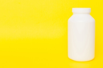 supplement pills with medicine bottle health care and medical top view. Vitamin tablets. Top view mockup bottle for pills and vitamins with green leaves, natural organic bio supplement, copy space