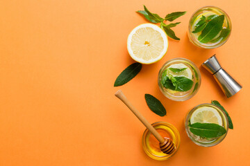 Caipirinha, Mojito cocktail, vodka or soda drink with lime, mint and straw on table background. Refreshing beverage with mint and lime in glass top view flat lay