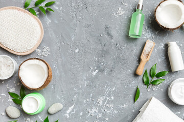 Coconut with jars of coconut oil and cosmetic cream on colored background. Top view. Free space for your text. Natural spa coconut cosmetics and organic treatment concept Coconut Spa composition