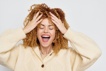woman expressing joy, bright mood, curly hair, light sweater, emotional happiness, carefree feeling...
