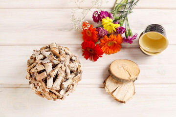 Florist at work: woman shows how to make table decoration with flowers and birch ball. Step by step, tutorial.