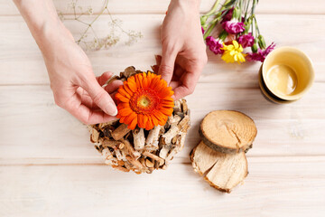 Florist at work: woman shows how to make table decoration with flowers and birch ball. Step by step, tutorial.