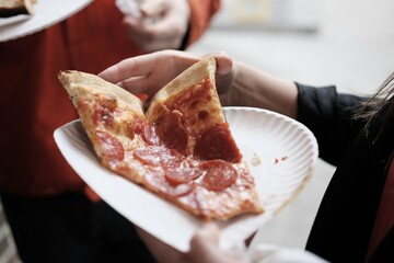 Slice of New York-style pepperoni pizza