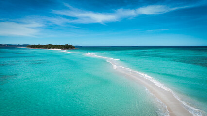 Aerial view of Nosy Iranja Island showcasing its stunning turquoise waters and sandbar at midday in Madagascar