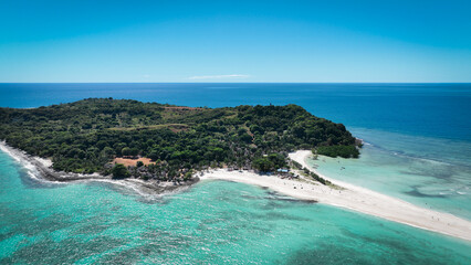 Aerial view of Nosy Iranja Island in Madagascar showcasing lush greenery and pristine beaches under a clear blue sky
